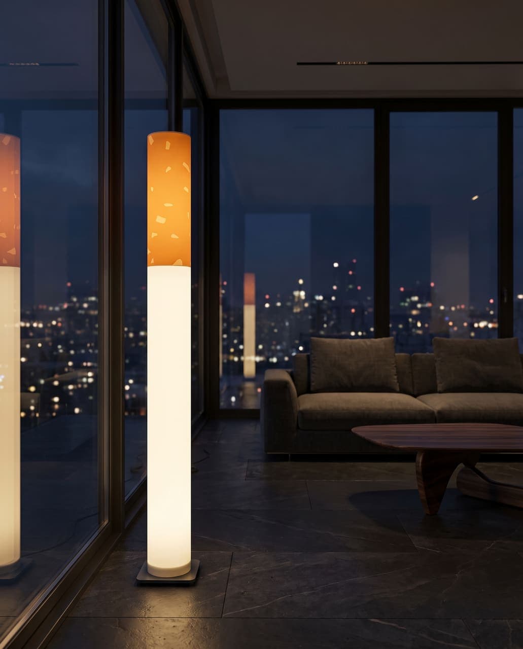 The lit floor lamp beside floor-to-ceiling glass in a dark penthouse, the city lights behind and its reflection in the window