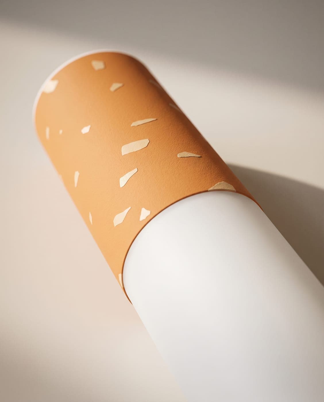 Close-up of the matte orange band with its small pale flecks meeting the white opal tube